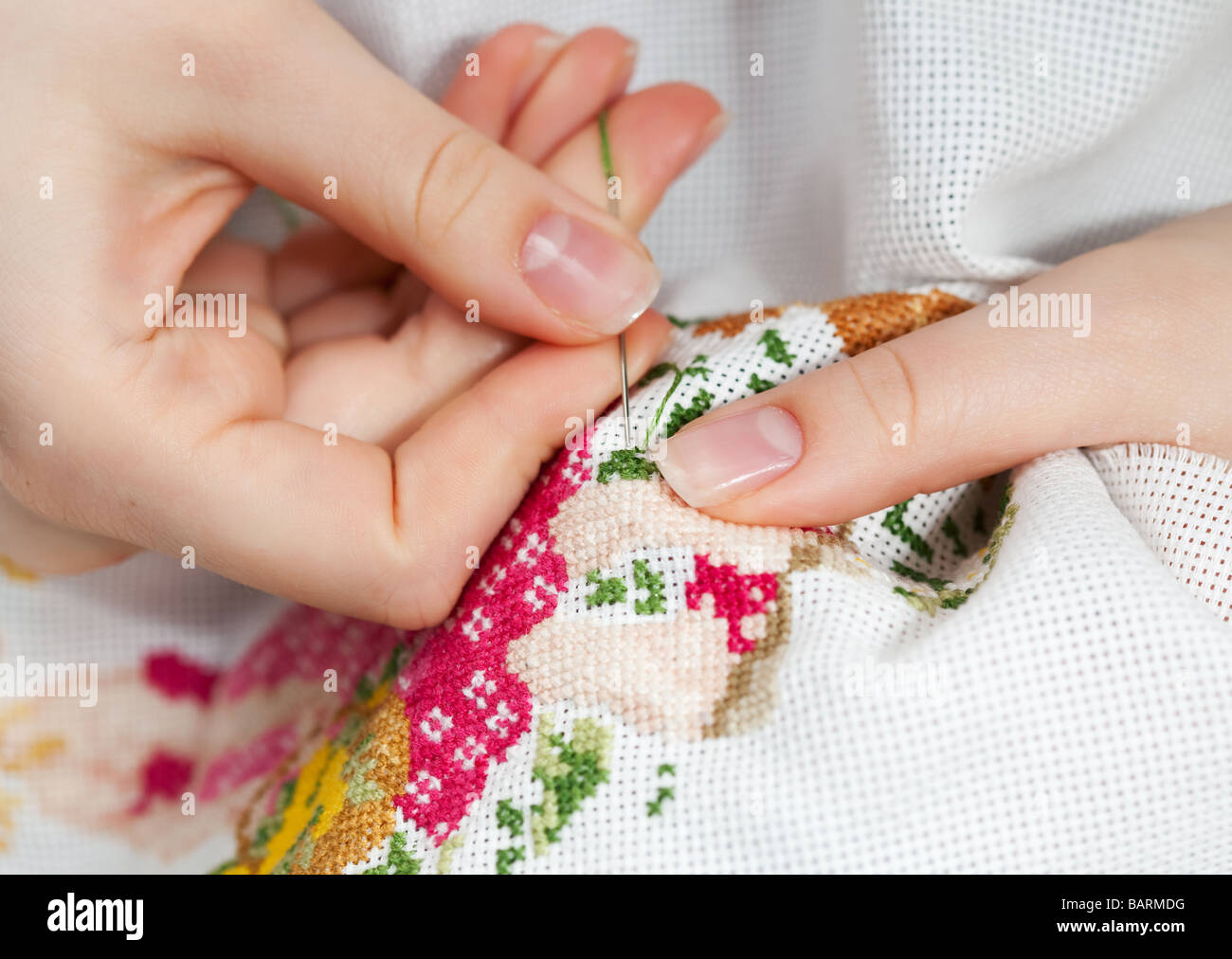 Woman hands doing cross stitch A close up of embroidery  Stock Photo