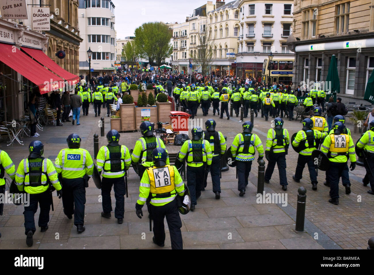 Lines of riot police contain crowds during may day protests in Brighton, Sussex, UK JPH0194 Stock Photo