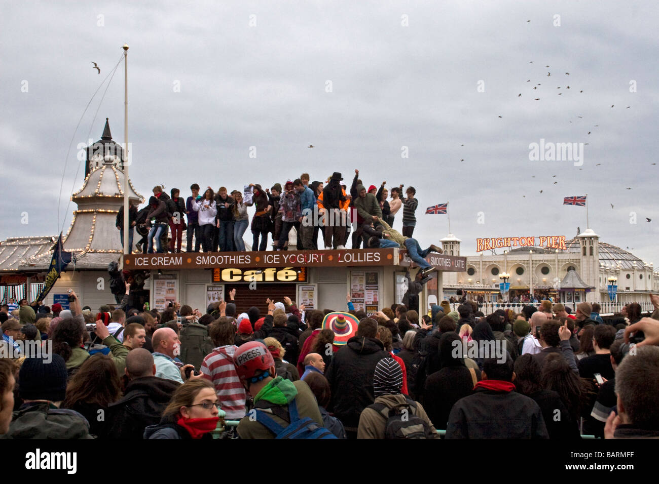 Group of people dancing on cafe roof by Palace pier at may day protests in Brighton, Sussex, UK JPH0200 Stock Photo