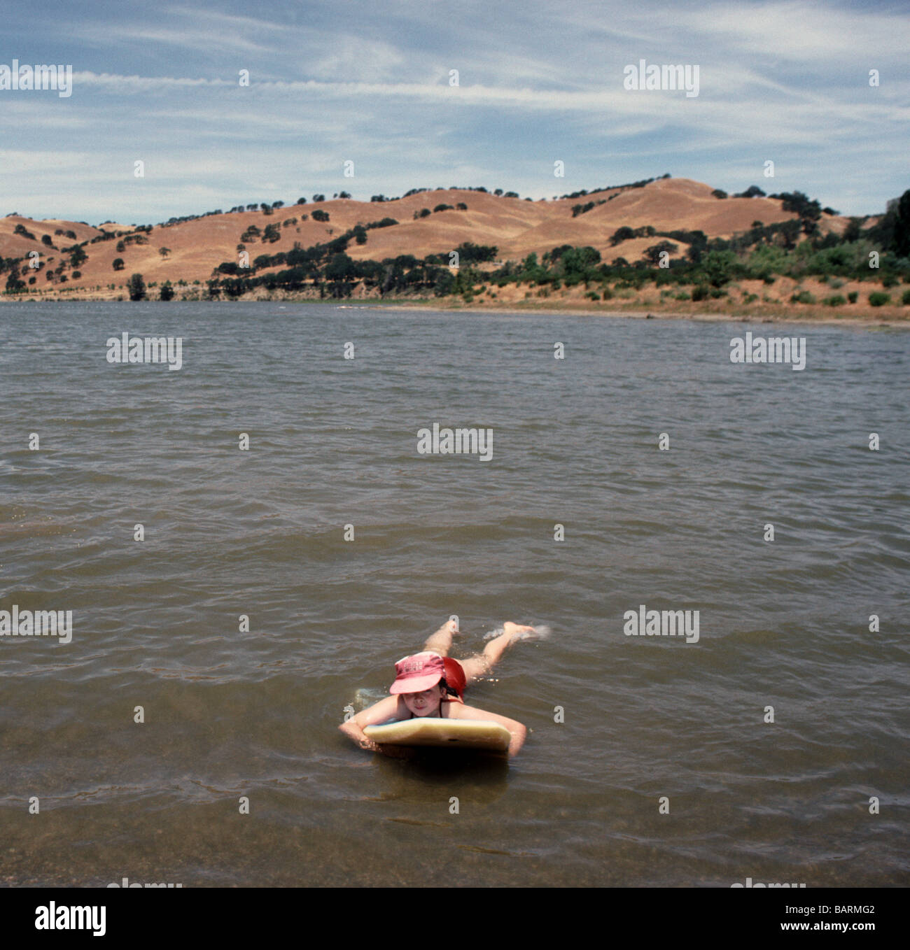 Girl floating in West Beach swimming area Lake Del Valle near Livermore California USA Stock Photo