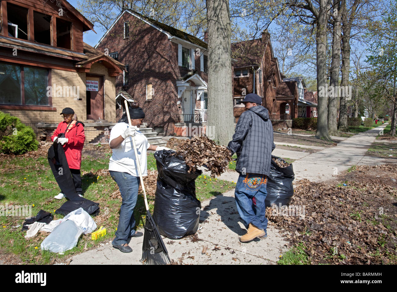 Volunteers clean trash from their neighborhood Stock Photo