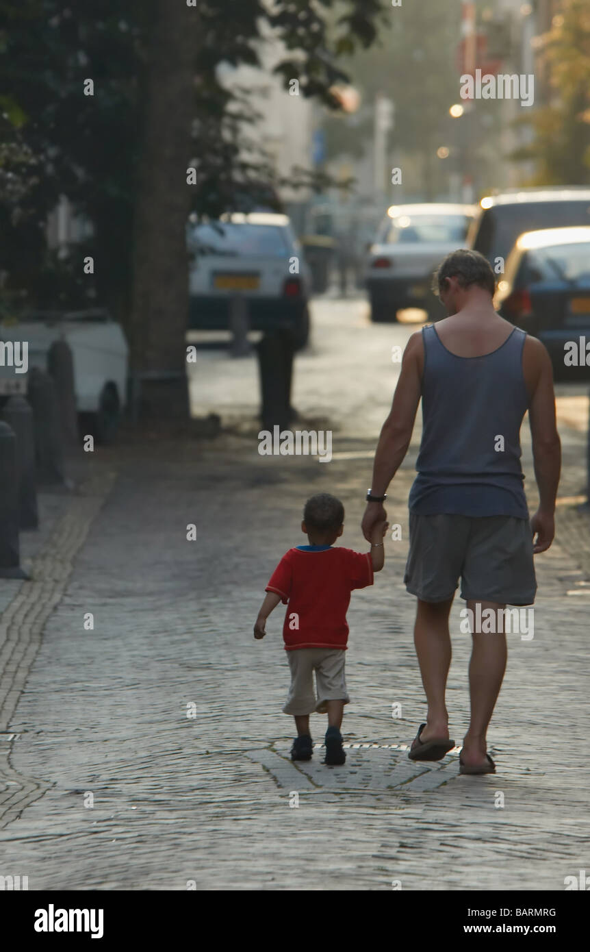 Father and son holding hands in an old street Stock Photo
