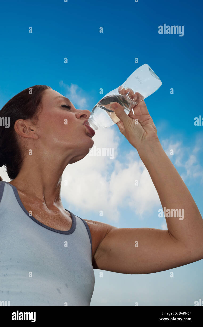 young woman drinking water after a workout Stock Photo Alamy