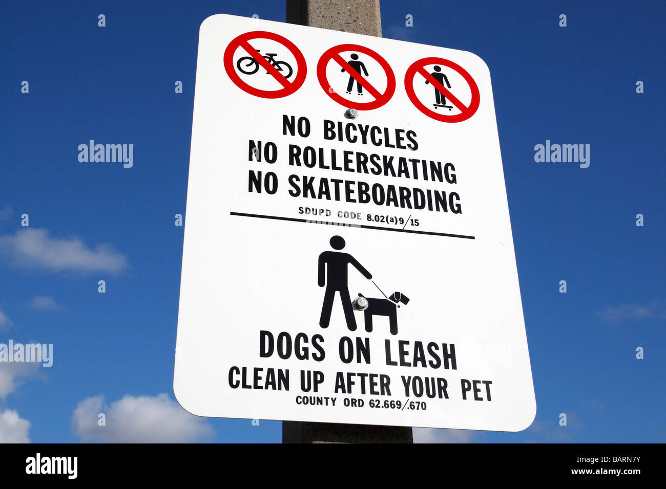 no bicycles no roller skating no skateboarding, dogs on a leash road sign along shelter island drive san diego california Stock Photo