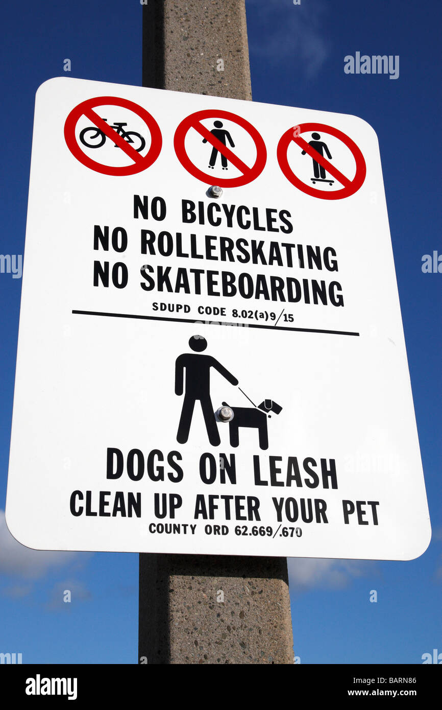 no bicycles no roller skating no skateboarding, dogs on a leash road sign along shelter island drive san diego california Stock Photo
