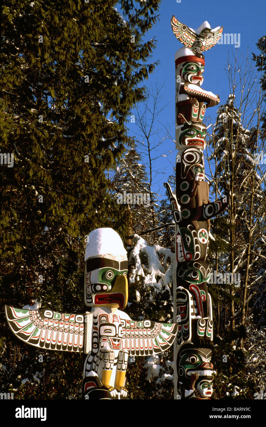 Snow Covered Kwakwaka'wakw (Kwakiutl) Totem Poles in Winter at Brockton Point in Stanley Park Vancouver British Columbia Canada Stock Photo