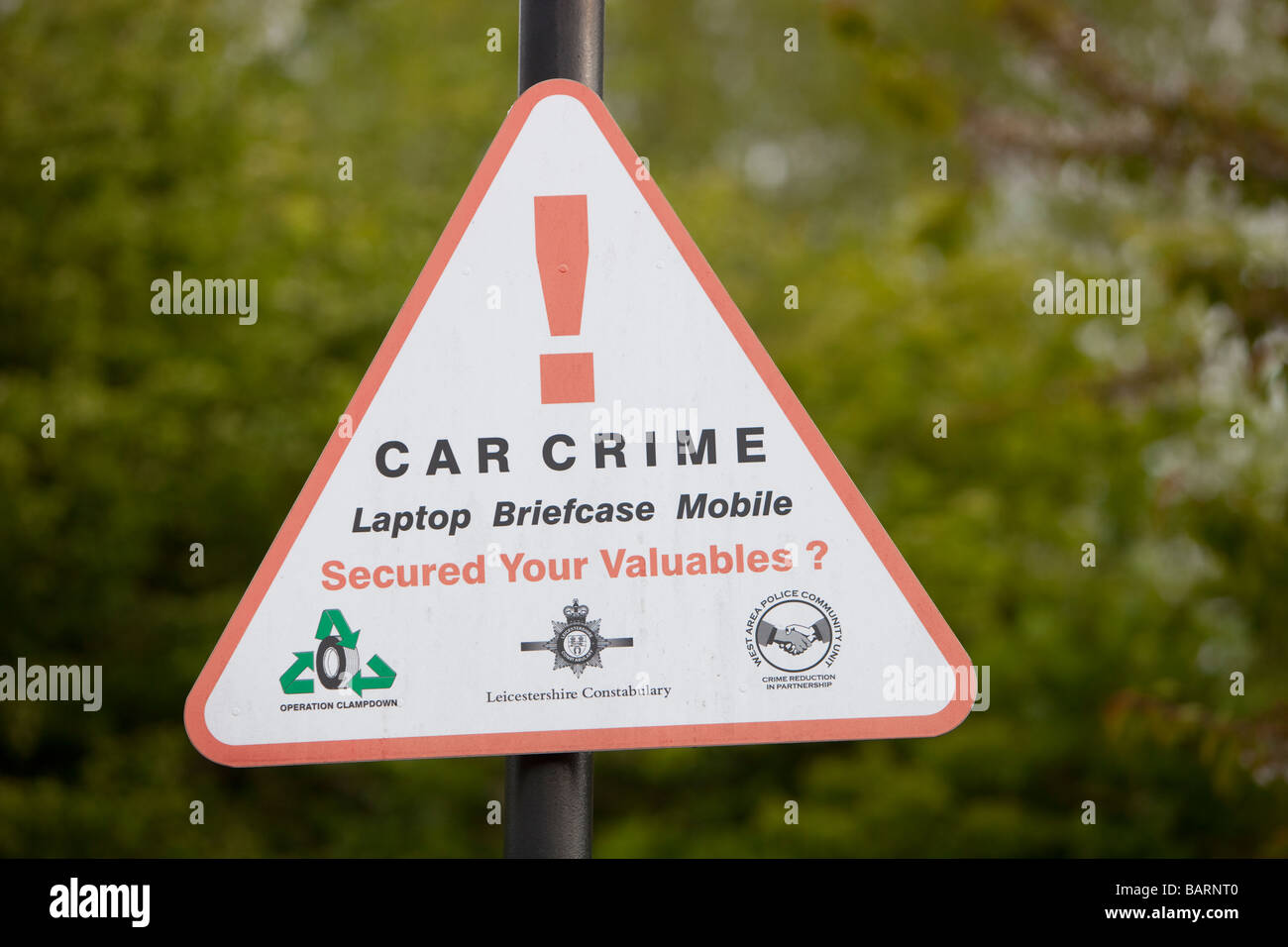 A car crime warning sign sign in a hotel car park in Leicester UK Stock Photo