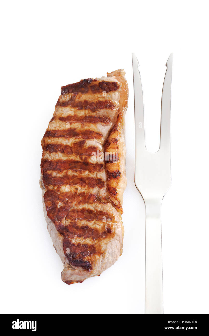 Grilled rumpsteak and meat fork, elevated view Stock Photo