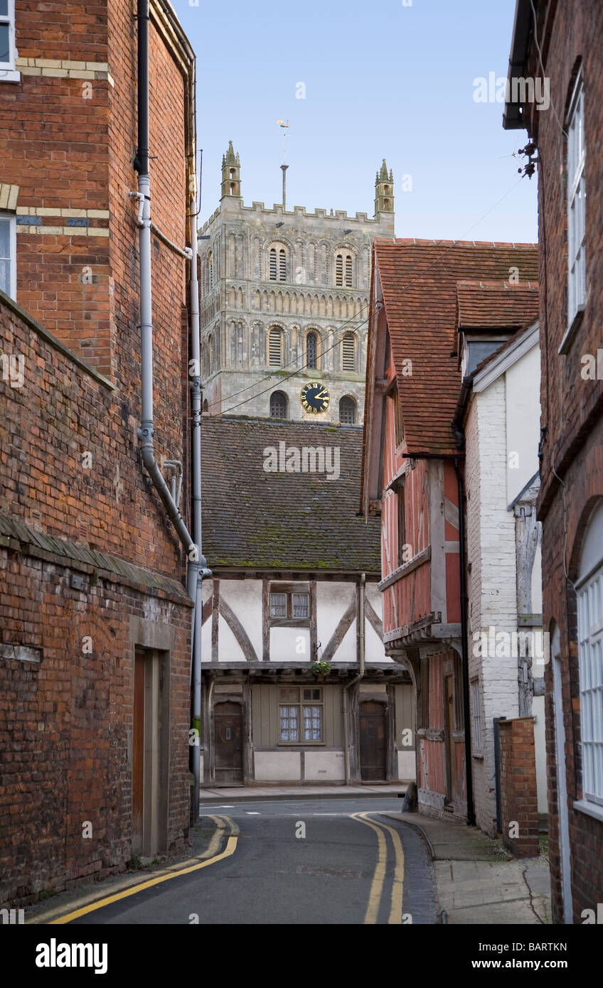 Tewkesbury side street with timber framed buildings and cathedral tower in the background Stock Photo