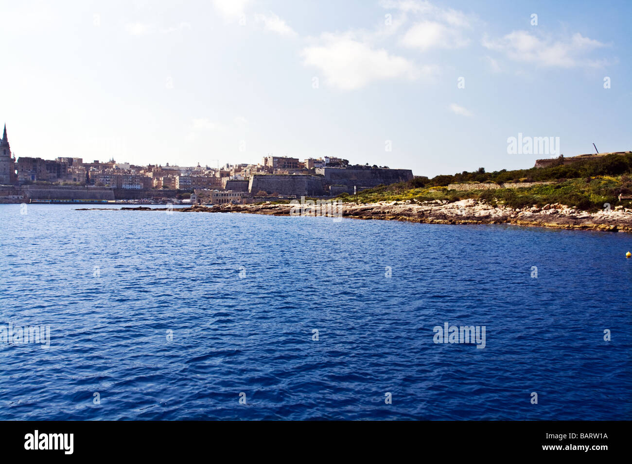 View of sea from Sliema - Valletta ferry passing Manoel Island with Valletta in distance. Stock Photo