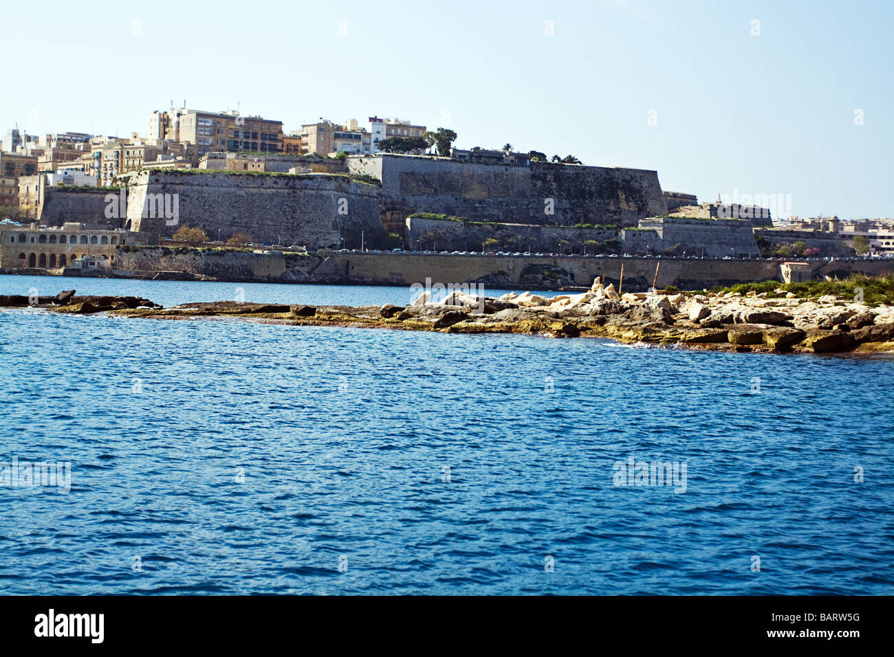 View of sea, rocks and Valletta from ferry boat from Sliema to Valletta. Stock Photo
