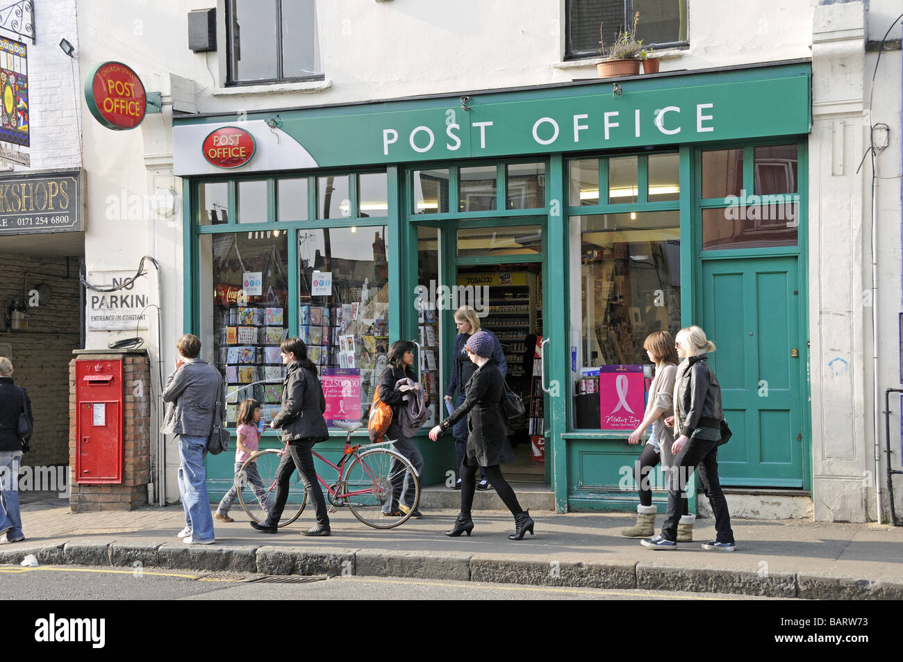 People passing Post Office Stoke Newington Church Street Hackney London England UK Stock Photo