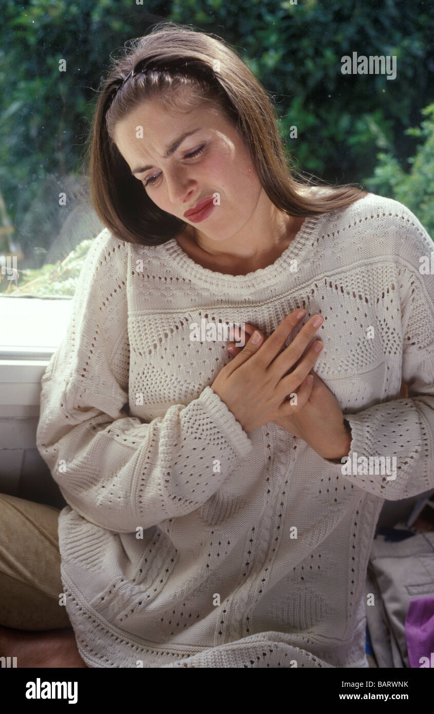 woman suffering with indigestion or heartburn Stock Photo