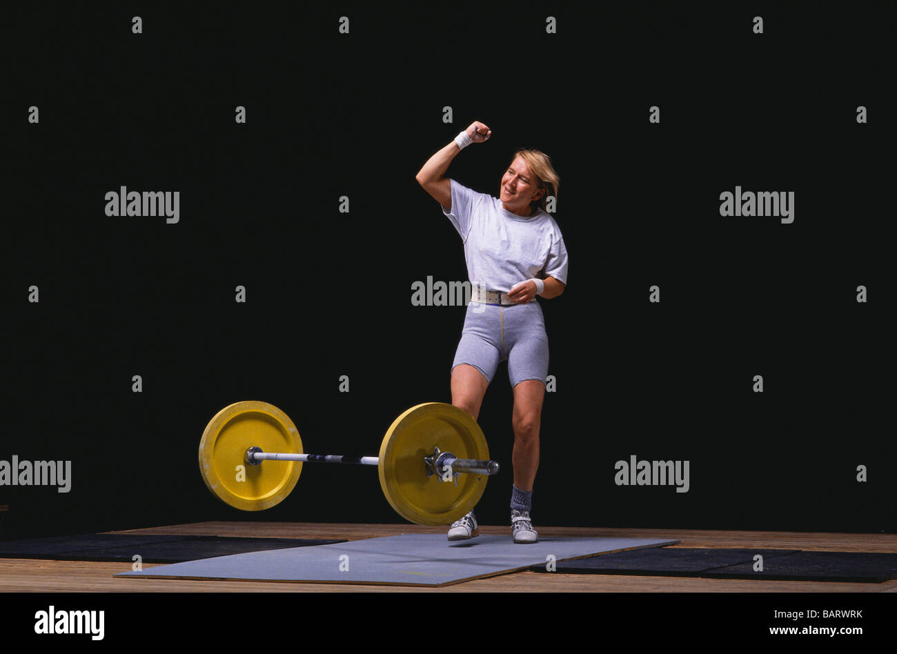 Female Olympic style weightlifter in action Stock Photo