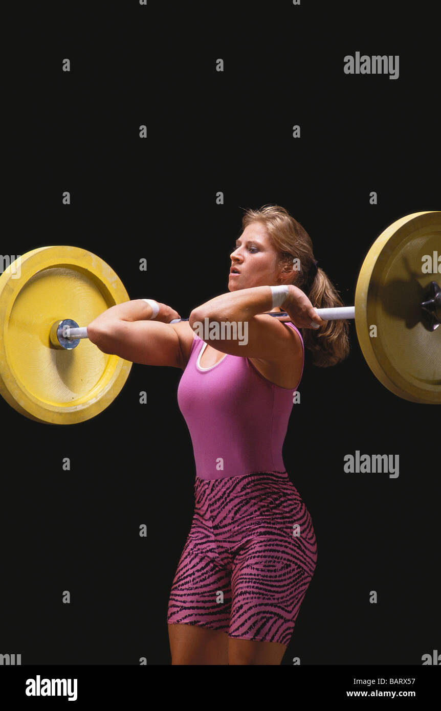 Female Olympic style weightlifter in action Stock Photo