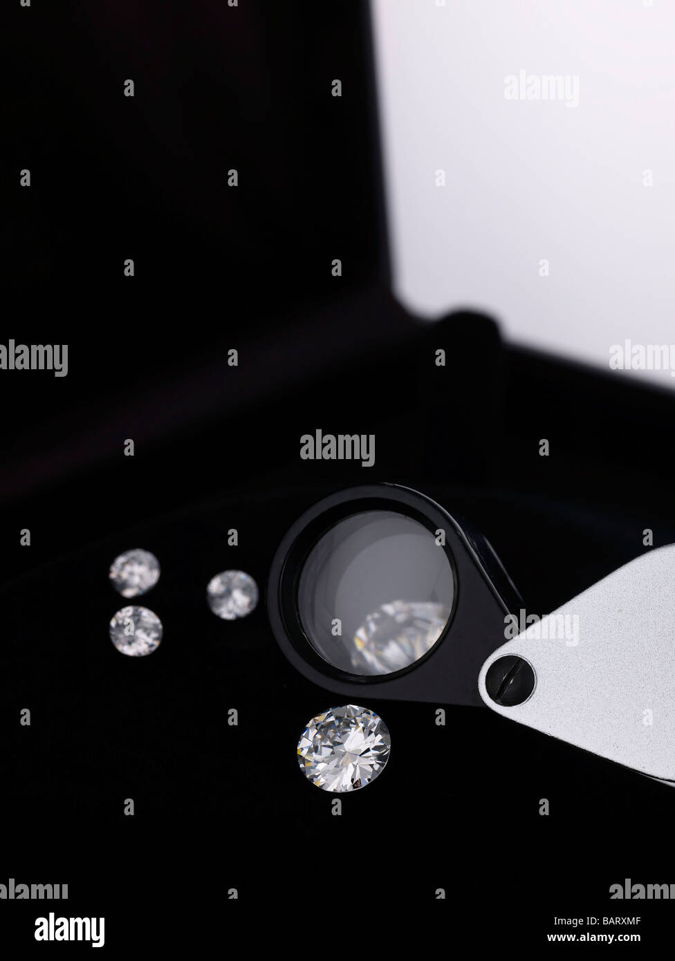 Diamonds and magnifying glass Stock Photo Alamy