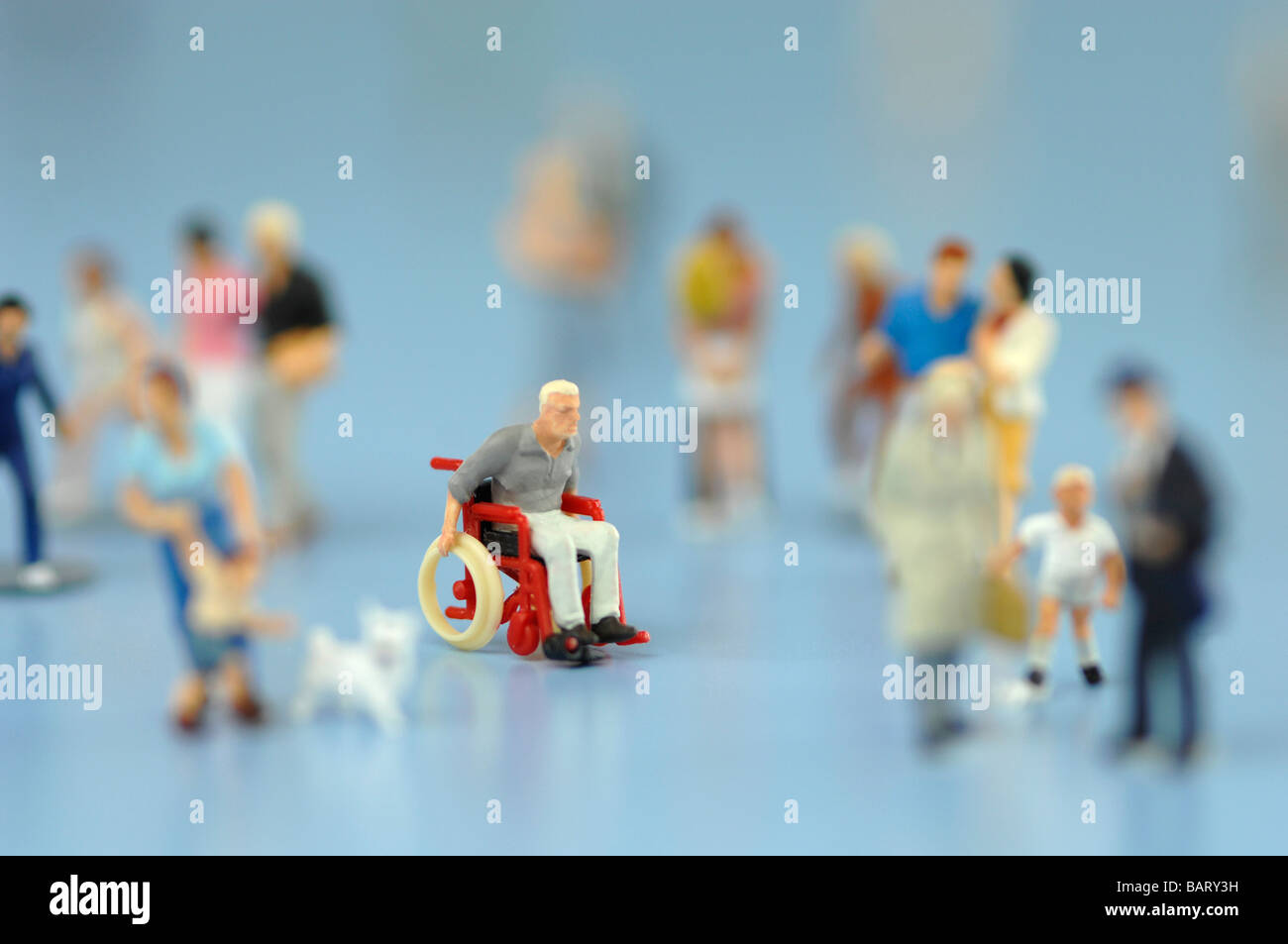 Wheelchairbound man figurine among people, close up Stock Photo Alamy