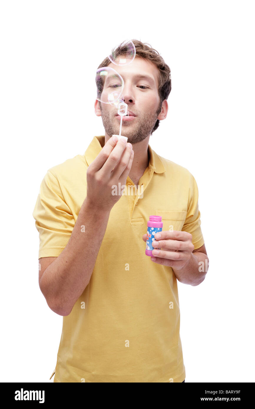 Young man blowing soap bubbles, portrait Stock Photo Alamy