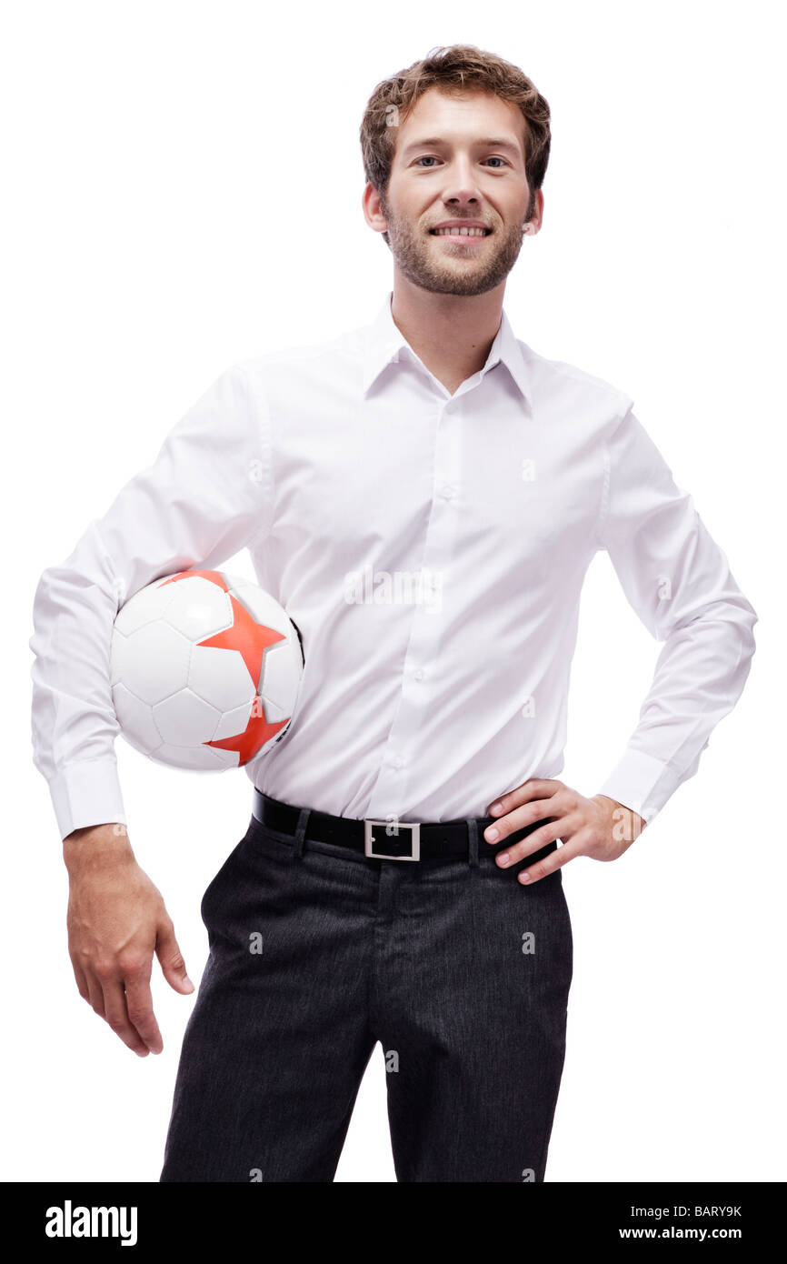Young man holding soccer ball, smiling, portrait Stock Photo - Alamy