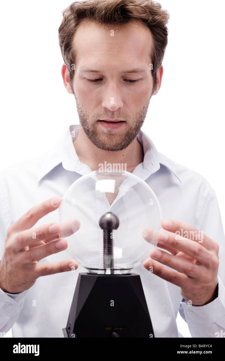 Young man with crystal ball, portrait Stock Photo Alamy