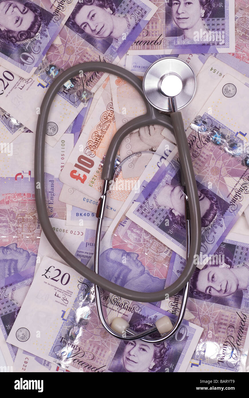 Stethoscope of British money Stock Photo Alamy