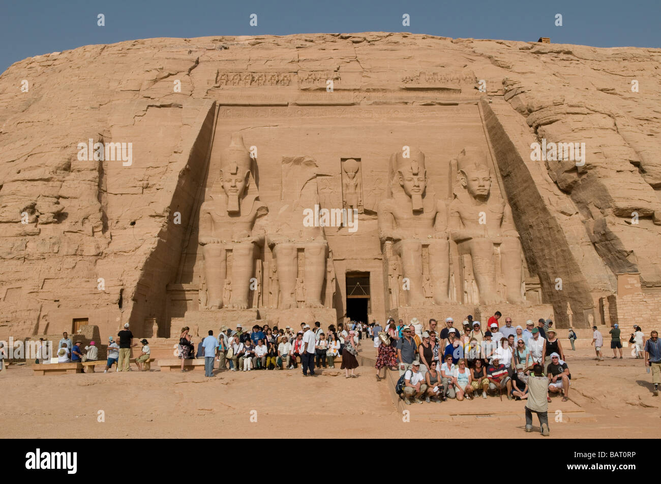 Tourists packed in front of the Sun Temple of Ramses II in Abu Simbel rock temples. Southern Egypt Stock Photo