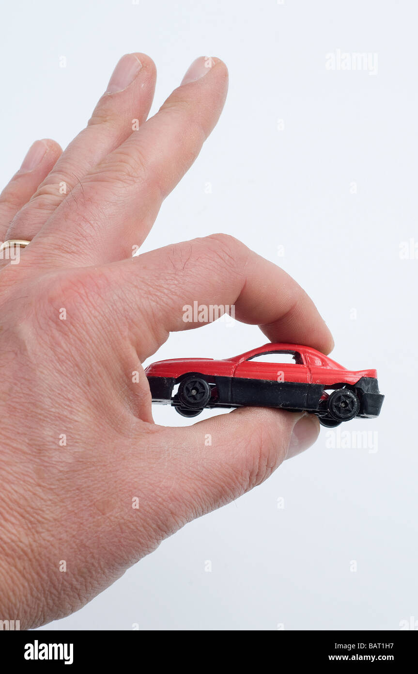 a small model car in a man's hand Stock Photo