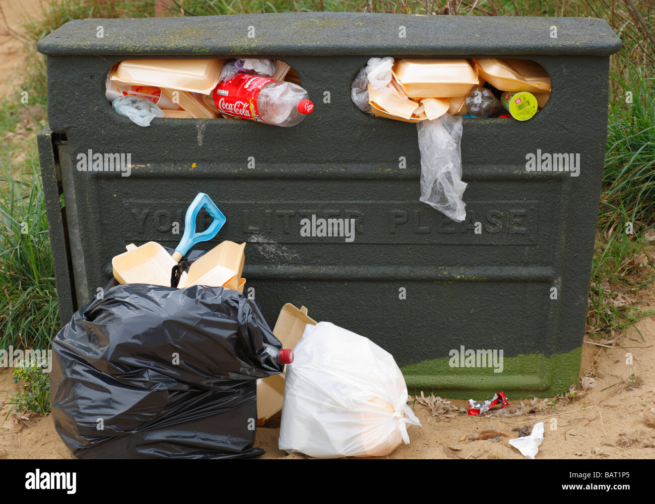 An overflowing litter bin at the seaside. Stock Photo
