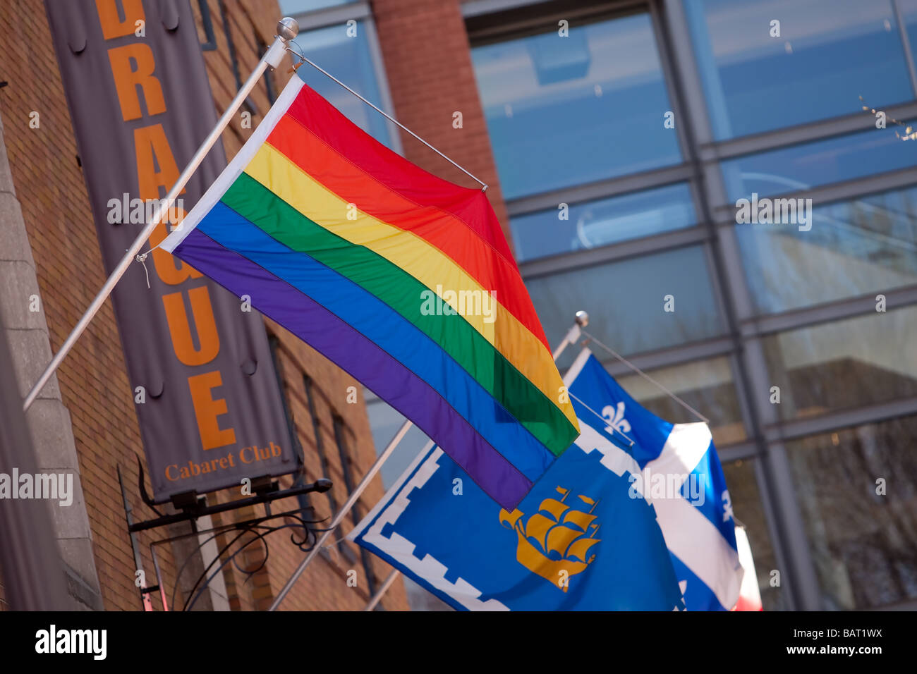 The Rainbow flag also known as Pride flag or Gay flag and the Quebec city flag are seen on Le Drague cabaret club in Quebec city Stock Photo