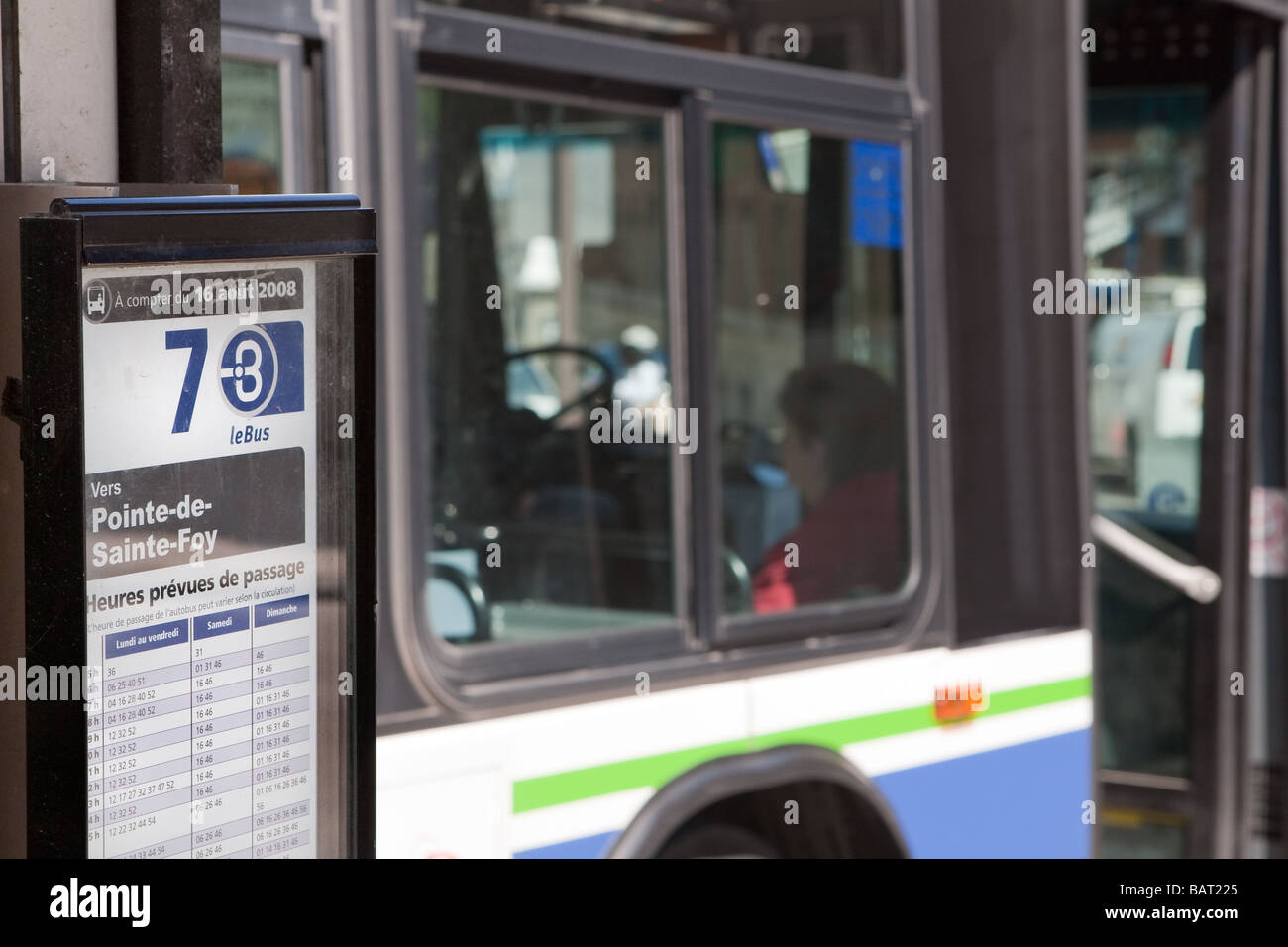 An RTC (reseau de transport de la capitale) bus schedule is seen on the Place D'Youville bus terminus in Quebec city Stock Photo