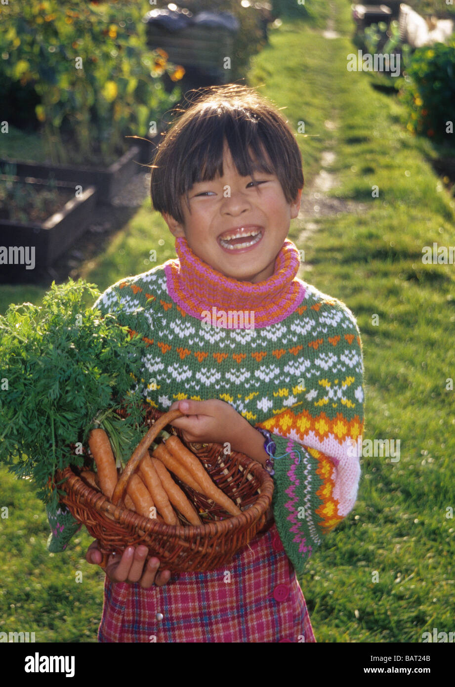 Little Chinese girl in allotments laughing. Stock Photo