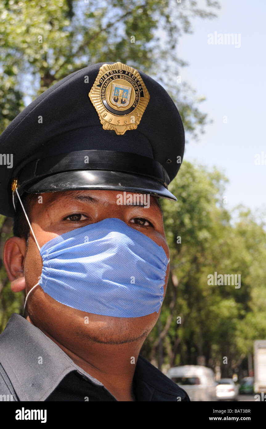 Closeup of a Mexican police officer who protects himself with a face mask against influenza Stock Photo