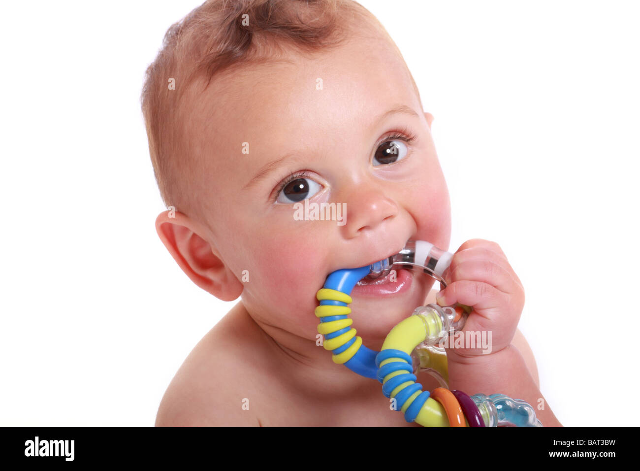 a 6 month old baby chewing on a toy teething aid boy Stock Photo