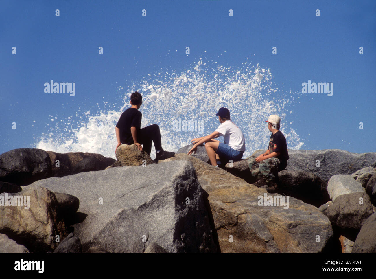 Three Boy Sit Rock Surf Wave Crash Water Sea Ocean Beach