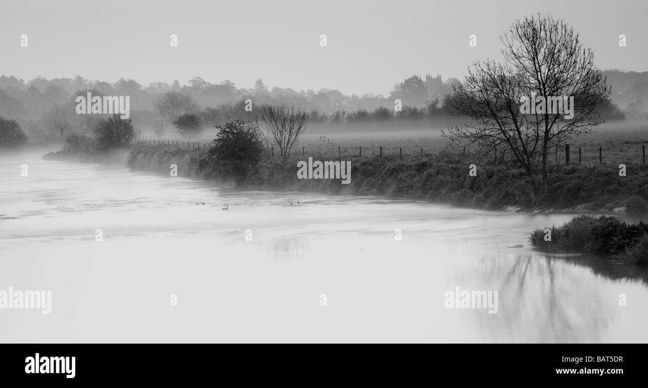 Landscape of misty cold morning river scene, black and white, Stour River Stock Photo