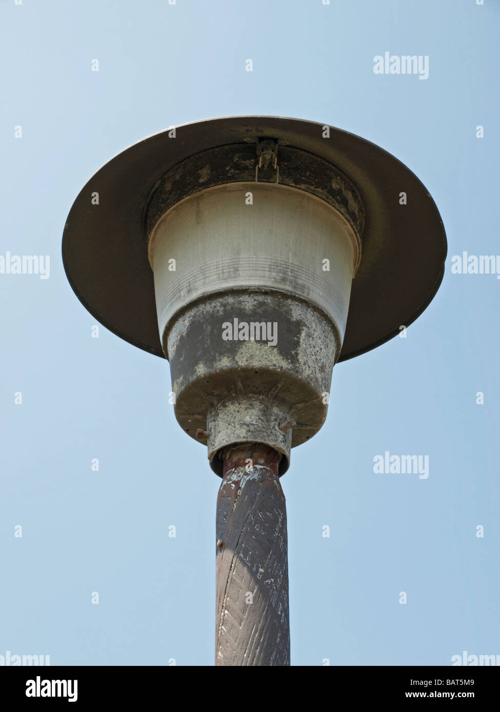 outdoor street yard lamp light, view upward seeing the lid underneath and the pole Stock Photo