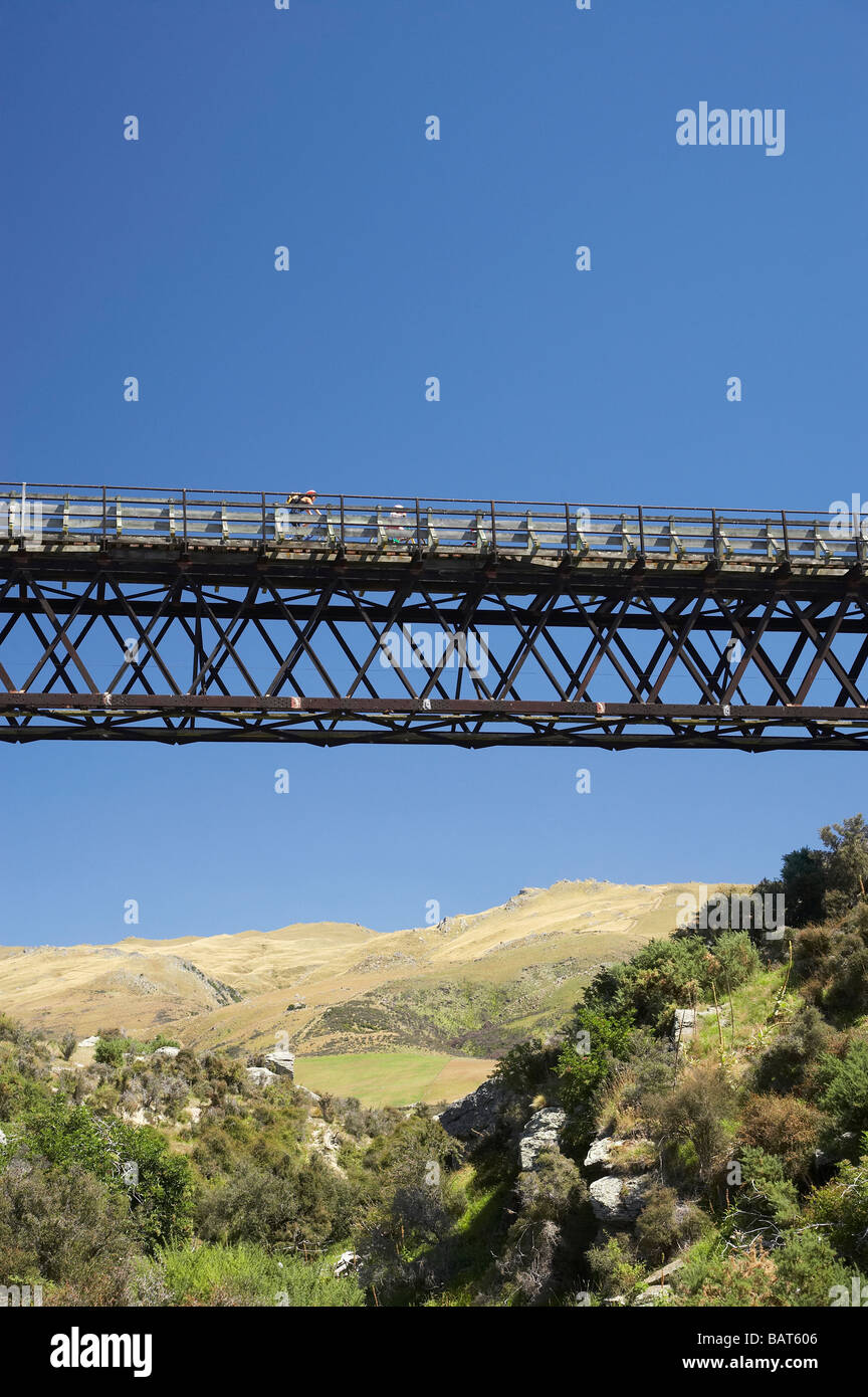 Cyclists on Five Mile Creek Bridge Otago Central Rail Trail near Hyde Central Otago South Island New Zealand Stock Photo