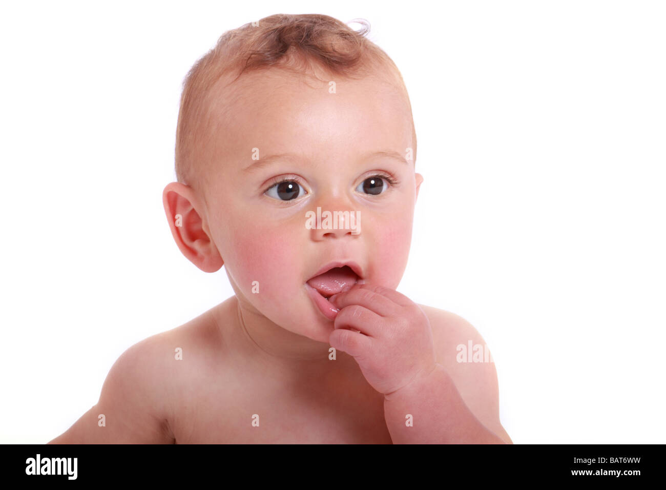 baby boy hand up to mouth happy looking off camera Stock Photo