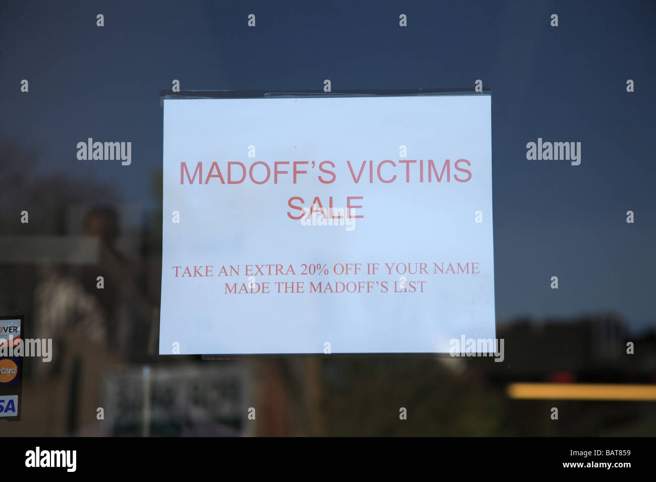Sign on fashion boutique in Greenwich village offering a discount to Victims of the Bernard Madoff Ponzi Scheme scandal Stock Photo