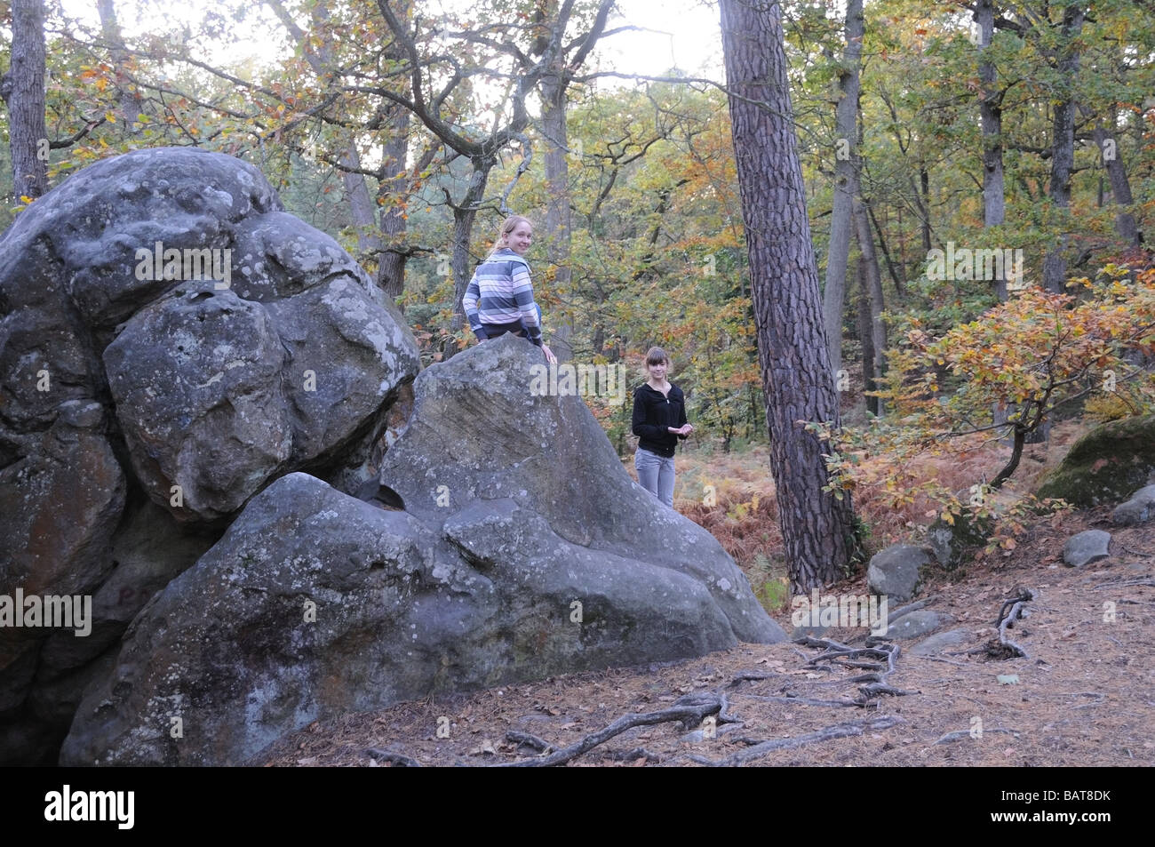two girls having fun in Fontainebleau forest on the rocks boulders Stock Photo