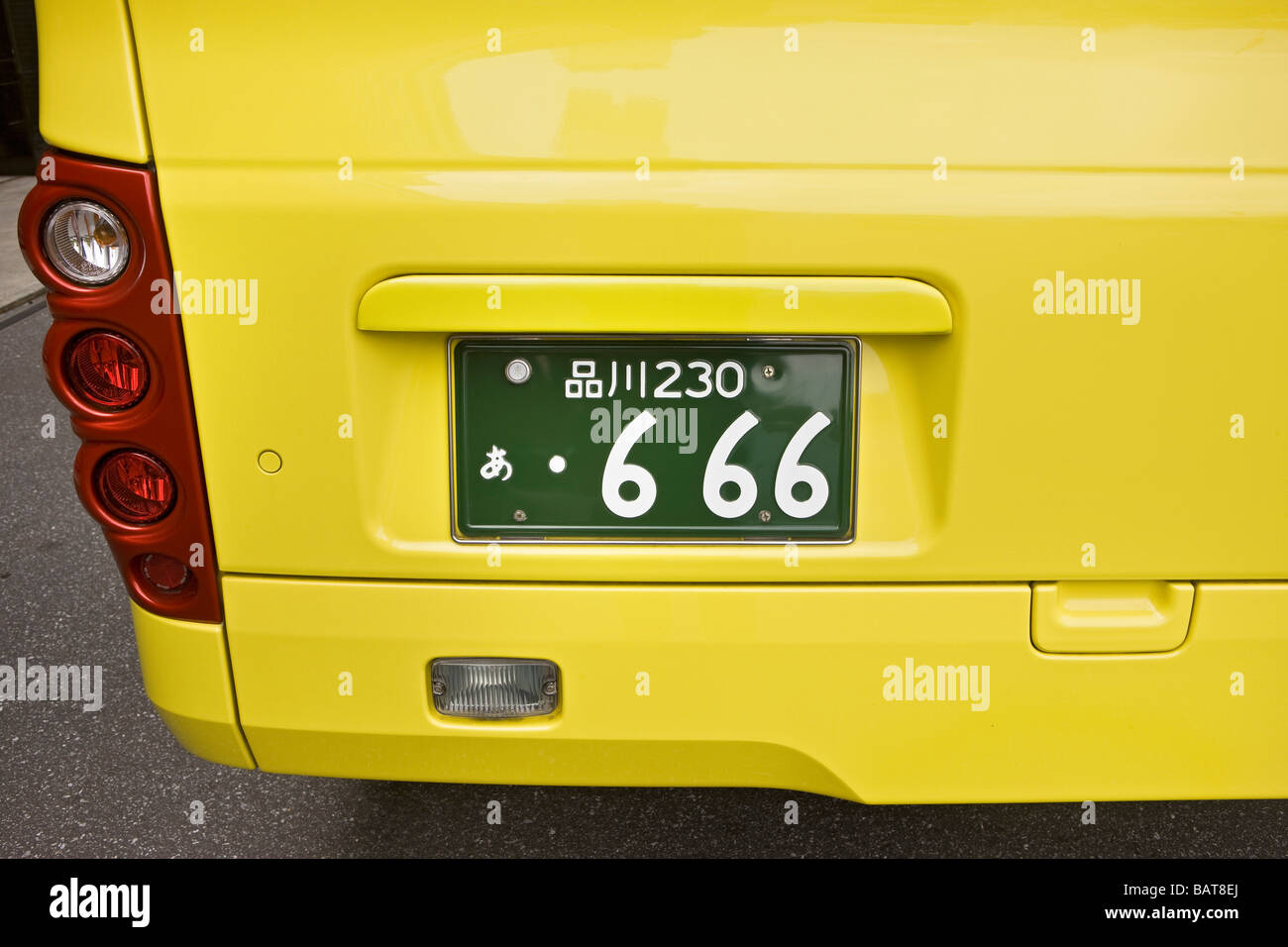 Yellow bus with 666 registration plate Stock Photo
