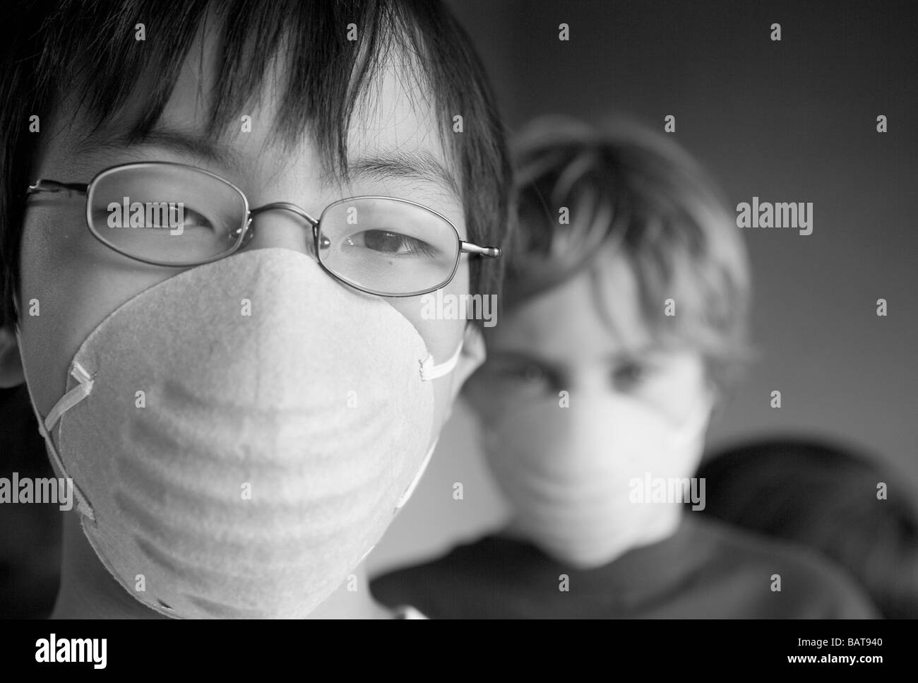 closeup of two children, ages 12 and 10 wearing masks Stock Photo