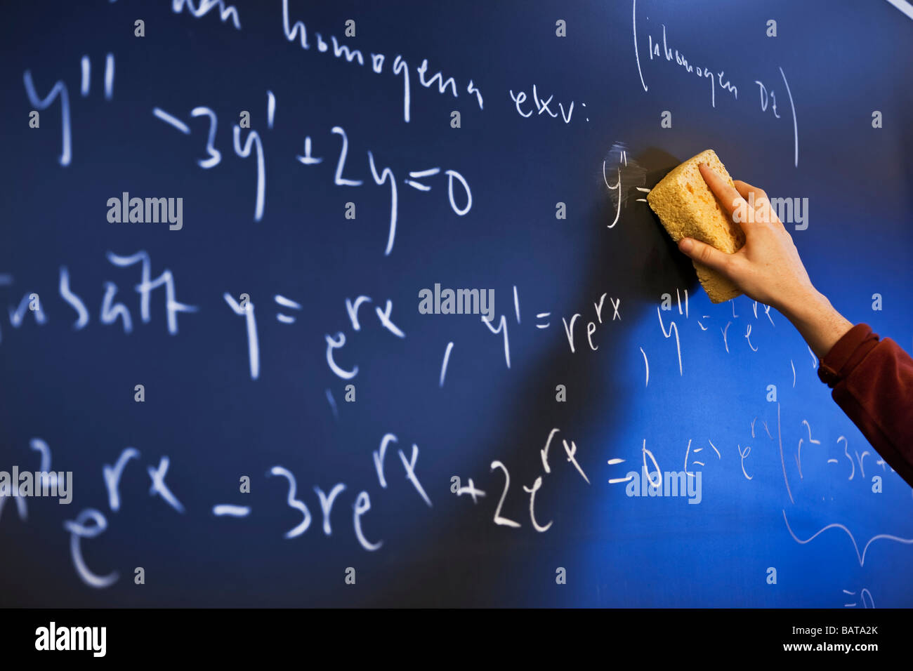 Erasing  complicated math formulas from black board Stock Photo