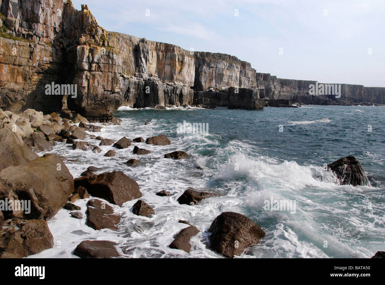 sea cliffs waves break on Pembroke Coastline in Wales Stock Photo