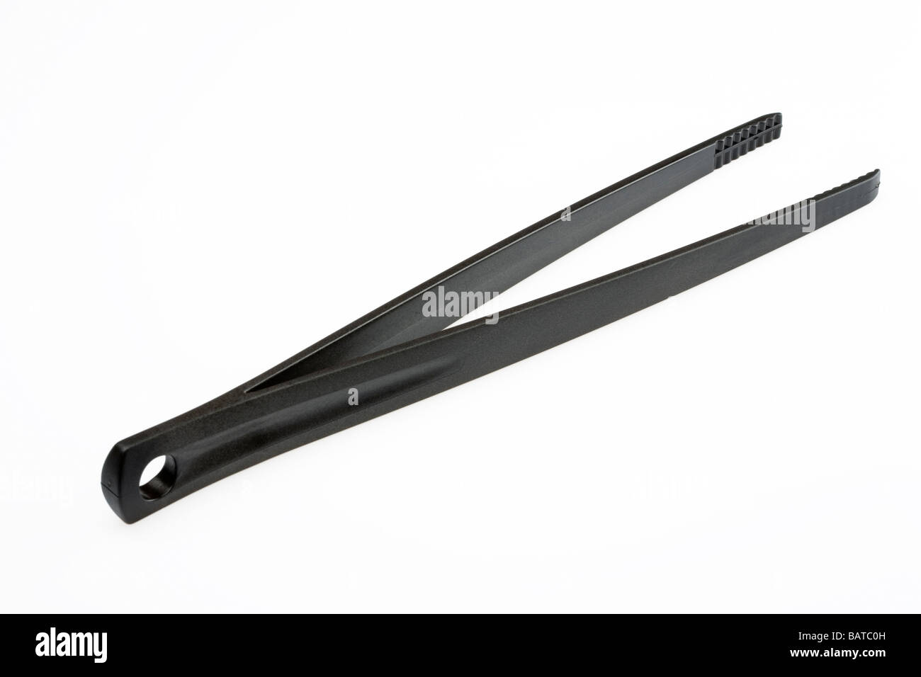 Black plastic tongs Stock Photo - Alamy