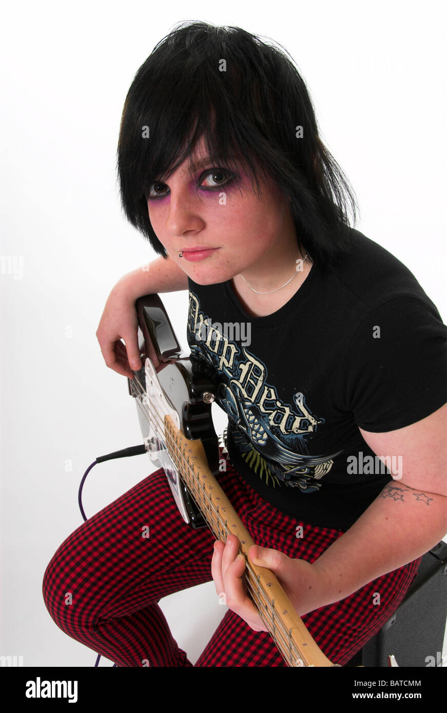 Emo Goth Teenage Girl Playing the Bass Guitar Stock Photo