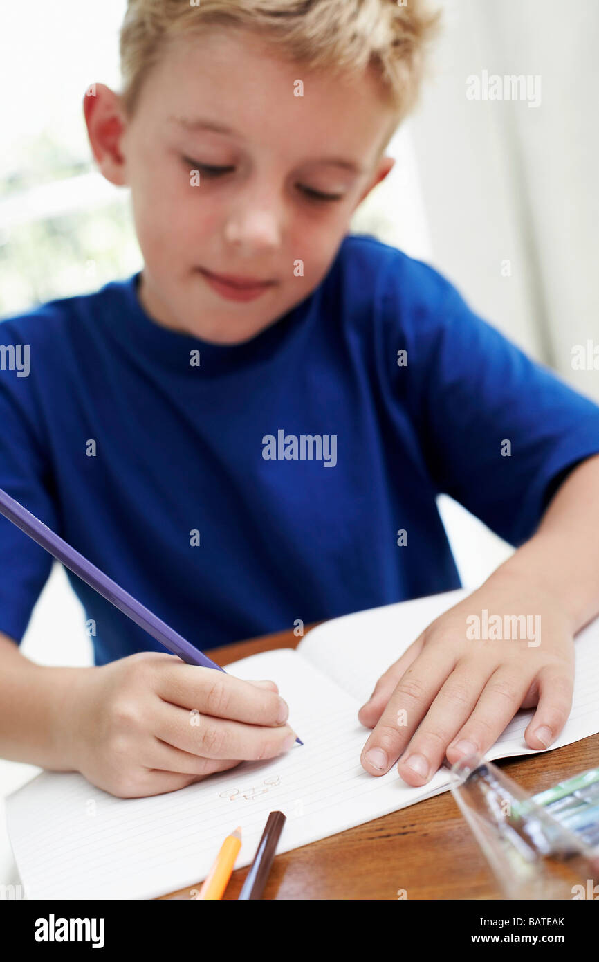 Boy drawing in an exercise book. He is six years old Stock Photo Alamy