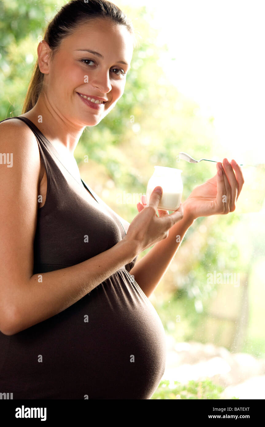pregnant woman eating yoghurt Stock Photo Alamy