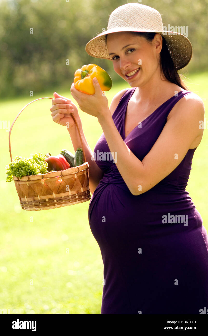 pregnant woman holding basket of vegetables Stock Photo - Alamy
