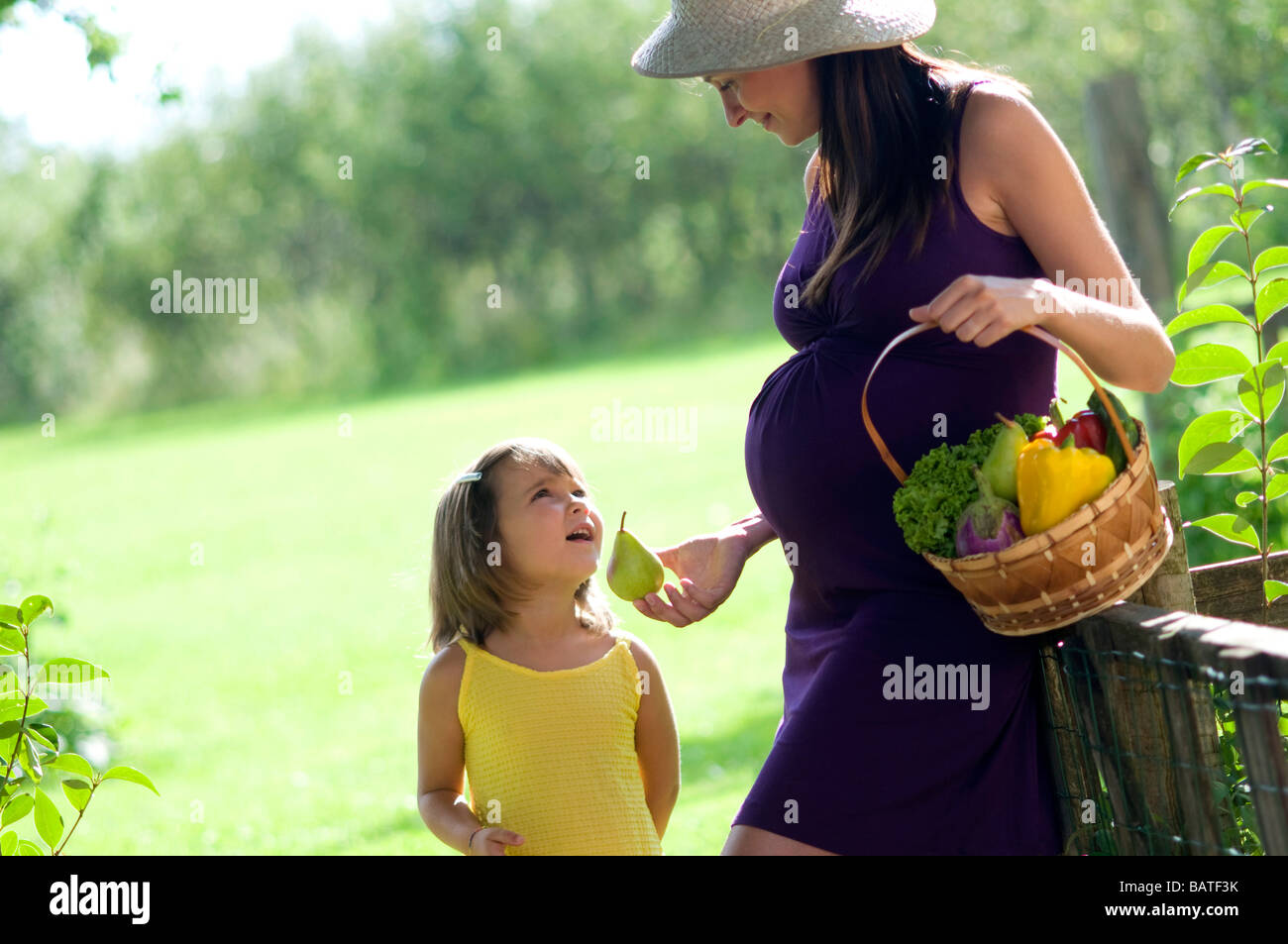pregnant woman with child and basket of vegetables Stock Photo - Alamy